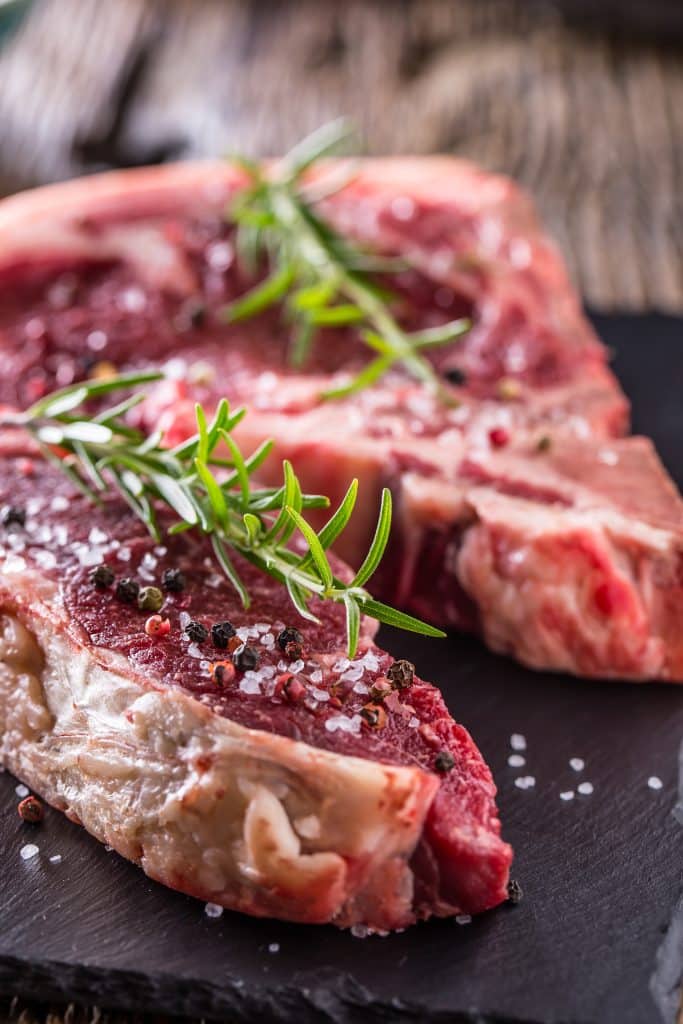 - beef raw steak raw fresh t bone steak with salt pepper rosemary